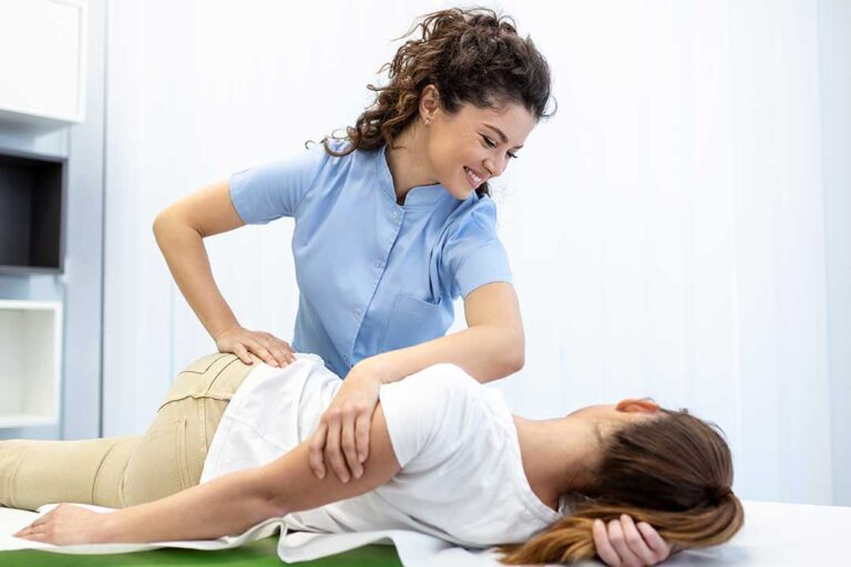Person seated safely while discussing spinning dizziness with a clinician in a bright examination room.